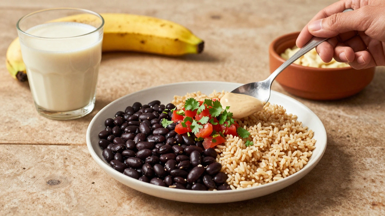 A simple vegan meal of black beans, rice, and salsa on a rustic plate with oat milk beside it.