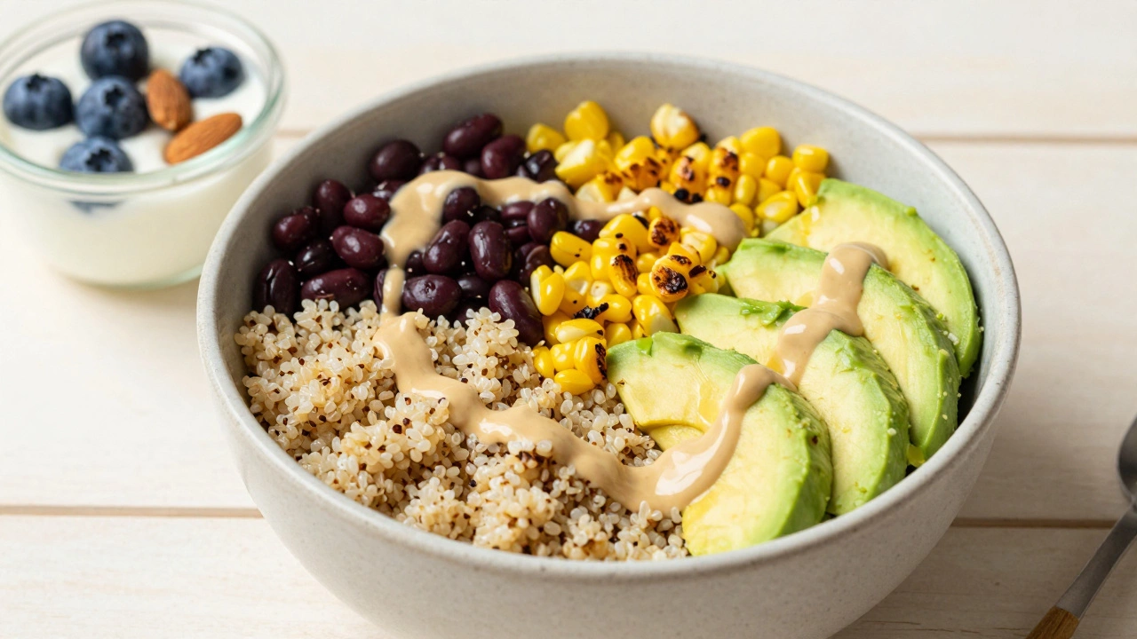A nutritious quinoa bowl with black beans, corn, and avocado next to a yogurt snack